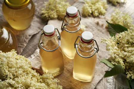 Bottles of homemade elderberry flower syrup made in springの写真素材