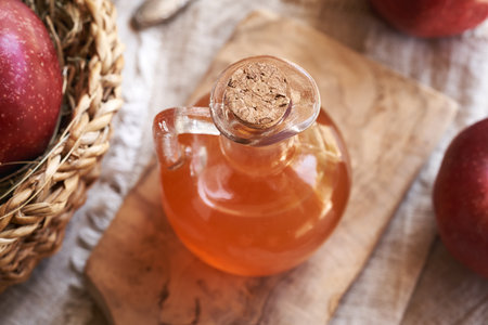Apple cider vinegar in a glass jug on a tableの写真素材