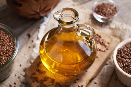 Flax seed oil in a glass bottle on a table. Nutritional supplement.の写真素材