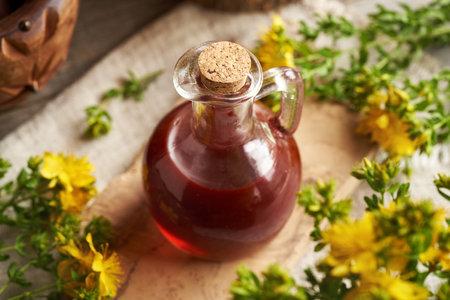 A jar of red oil made from fresh St. John's wort flowers in summerの写真素材