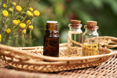 A bottle of santolina essential oil outdoors. Aromatherapy or alternative medicine.の写真素材