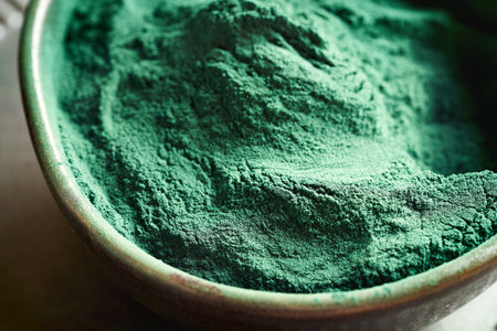 Green spirulina algae powder in a bowl, close upの写真素材