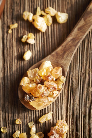 Frankincense resin crystals on a wooden spoon, top viewの写真素材