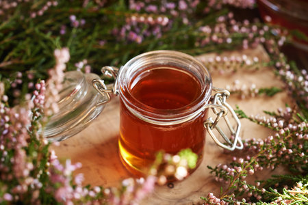 Wild heather flower syrup in a glass jarの写真素材