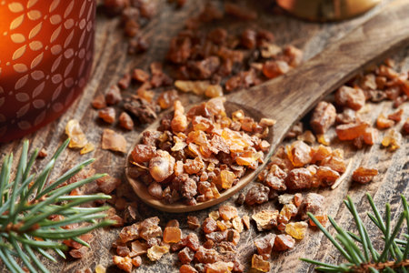 Myrrh resin on a wooden spoon  - ingredient for essential oils productionの写真素材