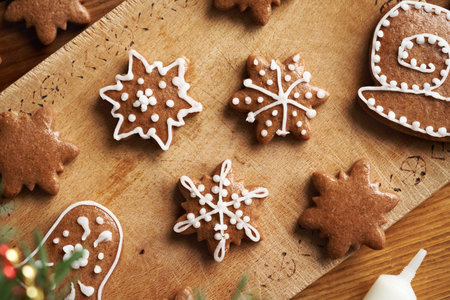 Star shaped homemade gingerbread Christmas cookies decorated with white icing, top view