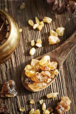 Frankincense or boswellia resin on a wooden spoon, top viewの写真素材