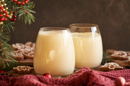 Two glasses of homemade eggnog with gingerbread cookies and Christmas decorationの写真素材
