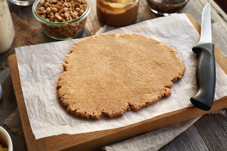 Rolled out dough made of whey protein powder, peanut butter and maple syrup - ingredient for homemade no-bake protein barsの写真素材