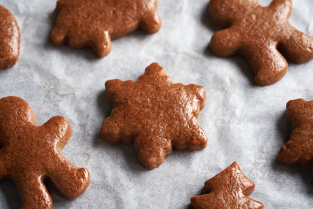 Star and man shaped homemade gingerbread Christmas cookies on a baking sheetの写真素材