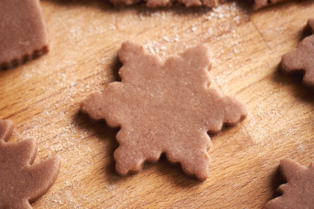 Star shape cut out from raw pastry dough - preparation of homemade gingerbread Christmas cookies, closeupの写真素材