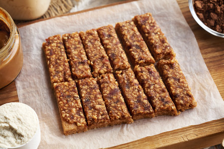 Homemade healthy snack bars made of whey protein powder, peanut butter, maple syrup and raw datesの写真素材
