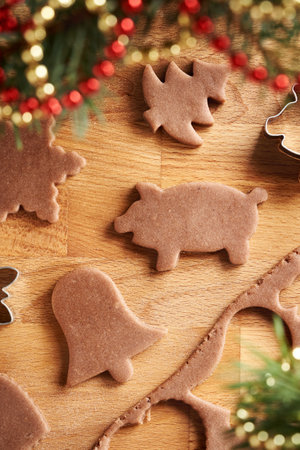 Shapes cut out from raw pastry dough - preparation of homemade gingerbread Christmas cookiesの写真素材