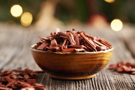 Red sandalwood chips in a wooden bowl - ingredient for aromatherapy essential oilsの写真素材
