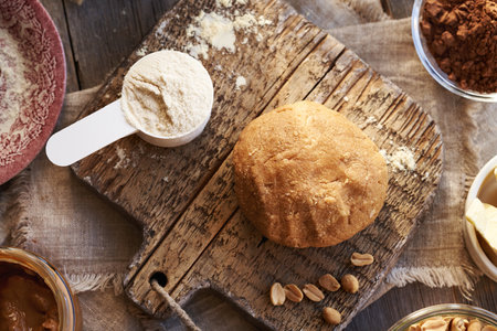 Ball of raw dough made of whey protein powder, maple syrup and peanut butter - ingredient for...