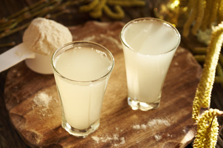 Fresh natural whey in two glass cups - protein rich healthy nutritional supplement