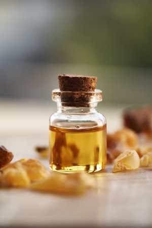 A transparent bottle of frankincense essential oil with frankincense resinの写真素材