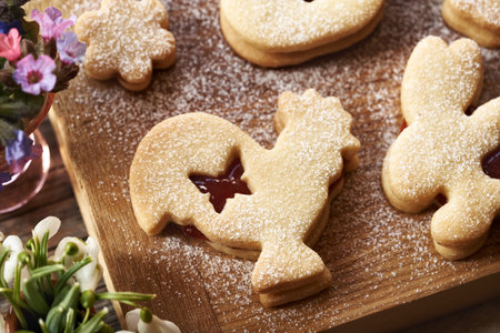 Linzer cookie in the shape of Easter animals filled with strawberry marmalade and dusted with sugar,...