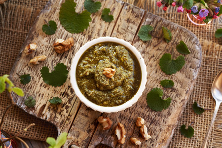 Pesto sauce made of fresh young garlic mustard leaves - wild edible plant harvested in spring, top viewの写真素材