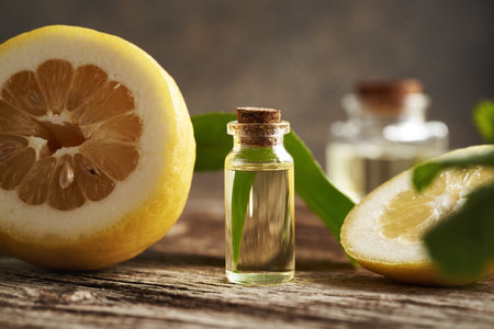 A bottle of aromatherapy essential oil with fresh lemon fruitの写真素材
