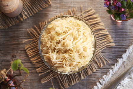 Fermented cabbage or sauerkraut in a glass bowl, top viewの写真素材