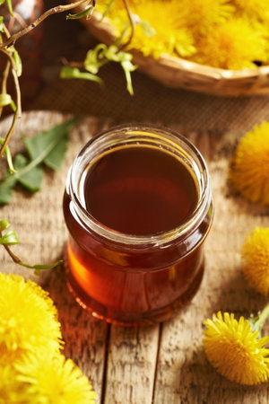 Dandelion honey - herbal syrup made of fresh Taraxacum flowers harvested in springの写真素材