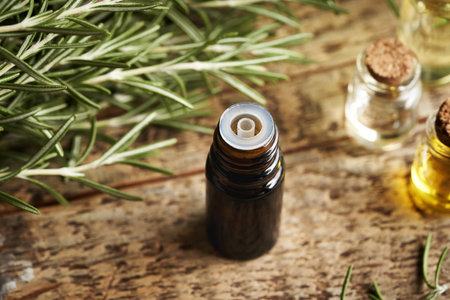 Rosemary essential oil in a dark glass bottleの写真素材