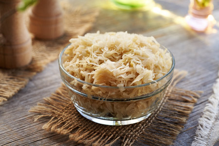 A glass bowl of fermented cabbage or sauerkrautの写真素材