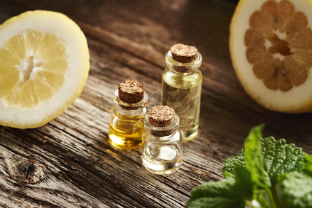 Bottles of aromatherapy essential oil with fresh lemonsの写真素材