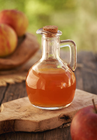 Apple cider vinegar in a glass jug outdoorsの写真素材