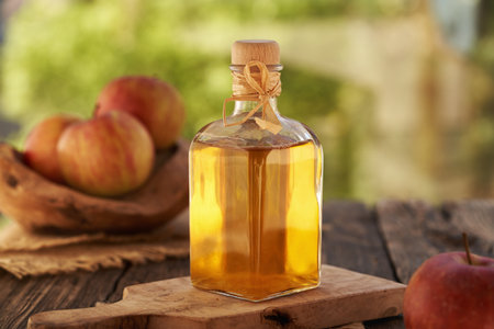 Apple cider vinegar in a glass bottle outdoorsの写真素材