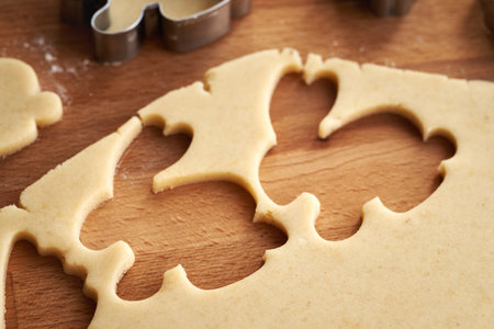 Cutting out bunny shapes from raw pastry dough - preparation of homemade Linzer Easter cookies, closeupの写真素材