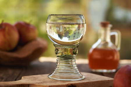 A glass cup of water with apple cider vinegar on a tableの写真素材