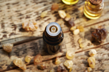A dark bottle of aromatherapy essential oil with frankincense resinの写真素材