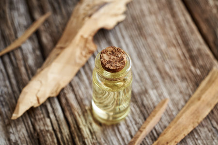 White sandalwood with a bottle of aromatherapy essential oilの写真素材