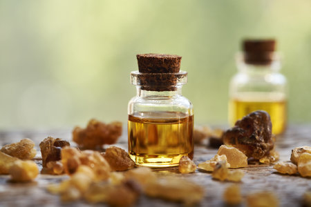 A bottle of frankincense essential oil on a table outdoorsの写真素材