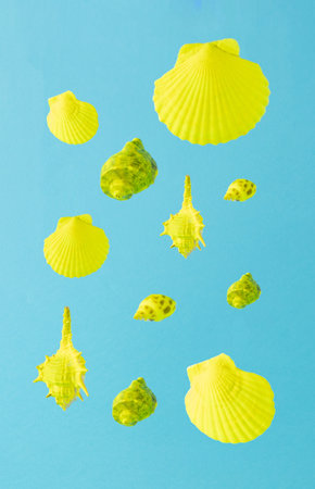 Yellow seashell pattern on blue background. Minimal concept.