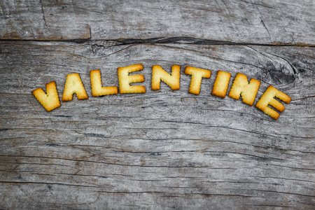 Cookies ABC in the form of word VALENTINE alphabet on old wood backgroundの写真素材