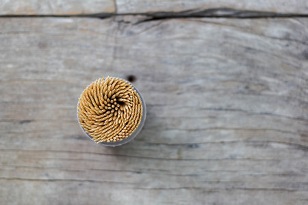 box with wooden toothpicks on wooden backgroundの写真素材