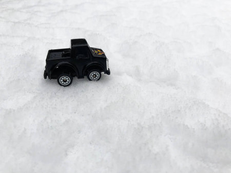 Mini toy maket black CUV car in the snow winter background cold weather problems roadの写真素材