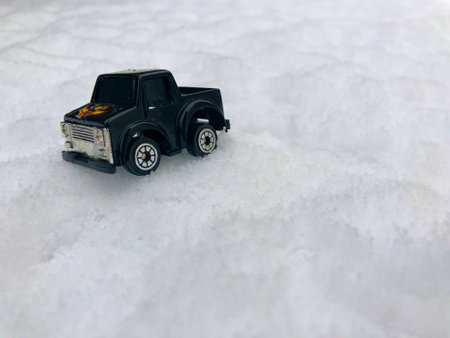 Mini toy maket black CUV car in the snow winter background cold weather problems roadの写真素材