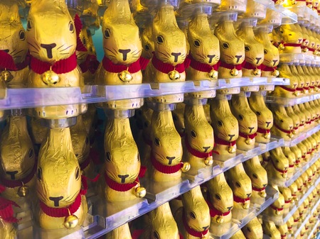 Easter bunny chocolate wrap in golden color aluminum foil with red collar rabbitの写真素材