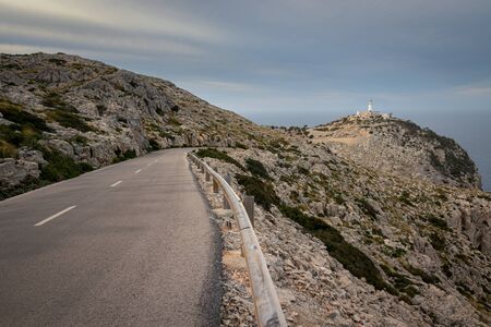 Cap De Formentor Lighthouse with winding road and rocks, near Pollenca and Alcudia, Mallorca, Spain.の写真素材