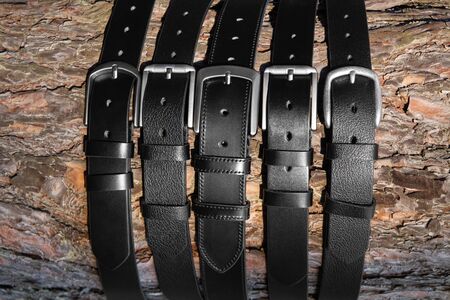pine bark covered with black leather belts for menの写真素材