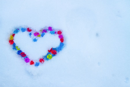 Heart made of multi-colored crystals on the snow