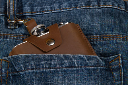 Hip flask in full grain leather case in denim blue jeans pocketの写真素材