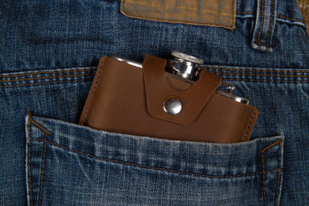 Hip flask in denim blue jeans pocketの写真素材