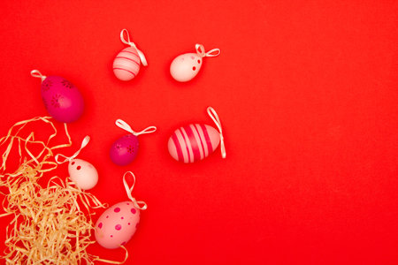 Easter eggs on red background with negative space for copy placementの写真素材