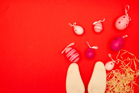 Red backdrop with Easter eggs and bunny ears, plus an area for copying during Easter holidaysの写真素材