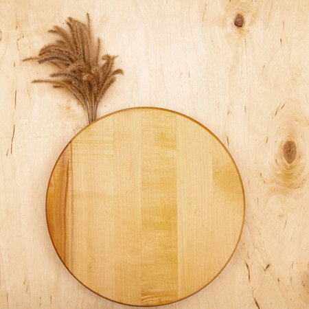 Fluffy decorative spikelets on wooden background with copy space. Greeting card with Whimsical grass on rustic wood.の写真素材